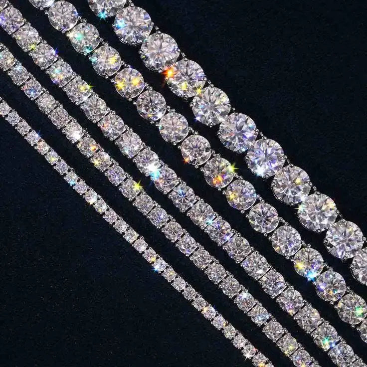 925 Sterling Silver Moissanite Tennis Chain – Iced Out VVS Moissanite 3mm-4mm Bracelet & Necklace

Experience luxury with the Top Icy HHMCT003 Moissanite Tennis Chain. Made from 925 sterling silver and featuring VVS Moissanite stones, this exquisite tennis bracelet/necklace is the perfect statement piece. The oval-cut Moissanite stones, renowned for their brilliance, are set using micro insert technology, ensuring maximum sparkle and durability.

Whether you're looking for a 3mm or 4mm width, this tennis ch